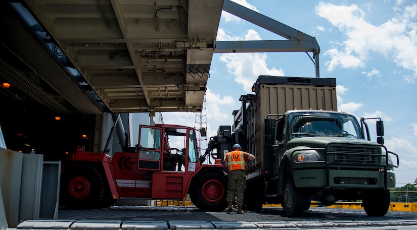 Sailors unload cargo during Exercise Turbo Distribution, a U.S. Transportation Command exercise May 21, 2014, aboard the USNS Watkins (T-AKR-315), moored at Wharf Alfa on Joint Base Charleston, S.C. Held May 15 through 22, Exercise Turbo Diesel allowed members of TRANSCOM’s 597th Transportation Battalion, Military Sealift Command’s Expeditionary Port Unit 110, Naval Cargo Handling Battalion One, along with JB Charleston’s 841st TB and ASLAC, the opportunity to exercise their skills in a joint envoironment. (U.S. Air Force photo/ Airman 1st Class Clayton Cupit)