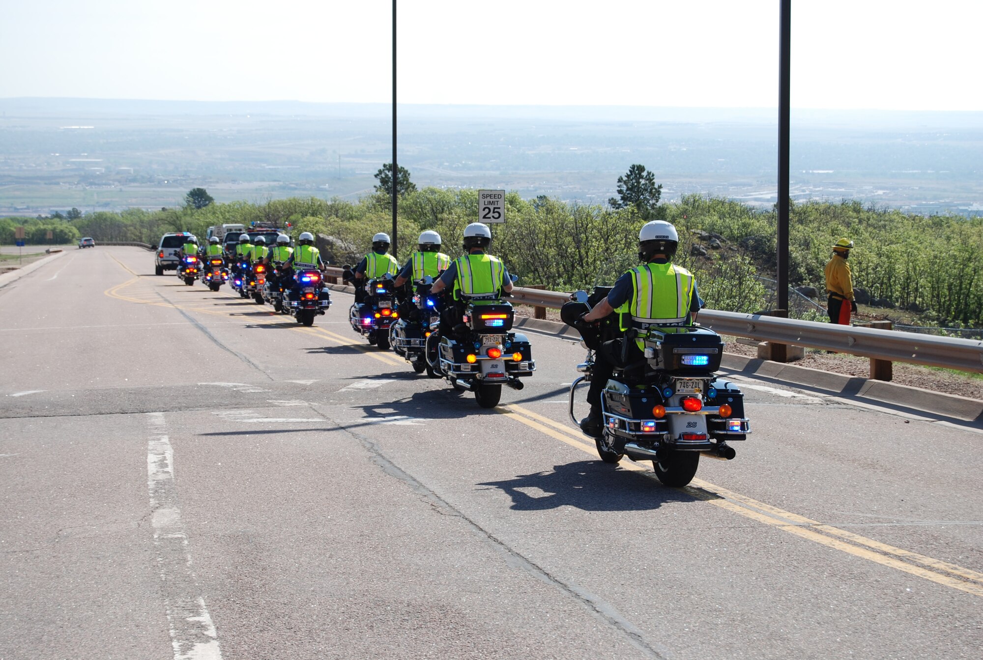 CHEYENNE MOUNTAIN AIR FORCE STATION, Colo. – Patrolmen with the Colorado Springs Police Department depart Cheyenne Mountain Air Force Station leading a motorcycle rally, part of National Police Week. The military motorcycle rally May 22 passed through the area military installations, including Peterson Air Force Base. (U.S. Air Force photo/Michael Golembesky)
