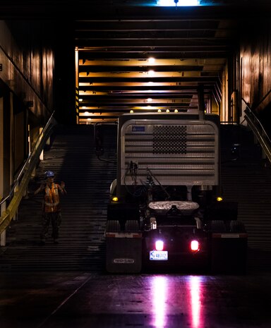 A Sailor signals a truck during Exercise Turbo Distribution, a U.S. Transportation Command exercise May 21, 2014, aboard the USNS Watkins (T-AKR-315), moored at Wharf Alfa on Joint Base Charleston, S.C. Held May 15 through 22, Exercise Turbo Diesel allowed members of TRANSCOM’s 597th Transportation Battalion, Military Sealift Command’s Expeditionary Port Unit 110, Naval Cargo Handling Battalion One, along with JB Charleston’s 841st TB and ASLAC, the opportunity to exercise their skills in a joint envoironment. (U.S. Air Force photo/ Airman 1st Class Clayton Cupit)