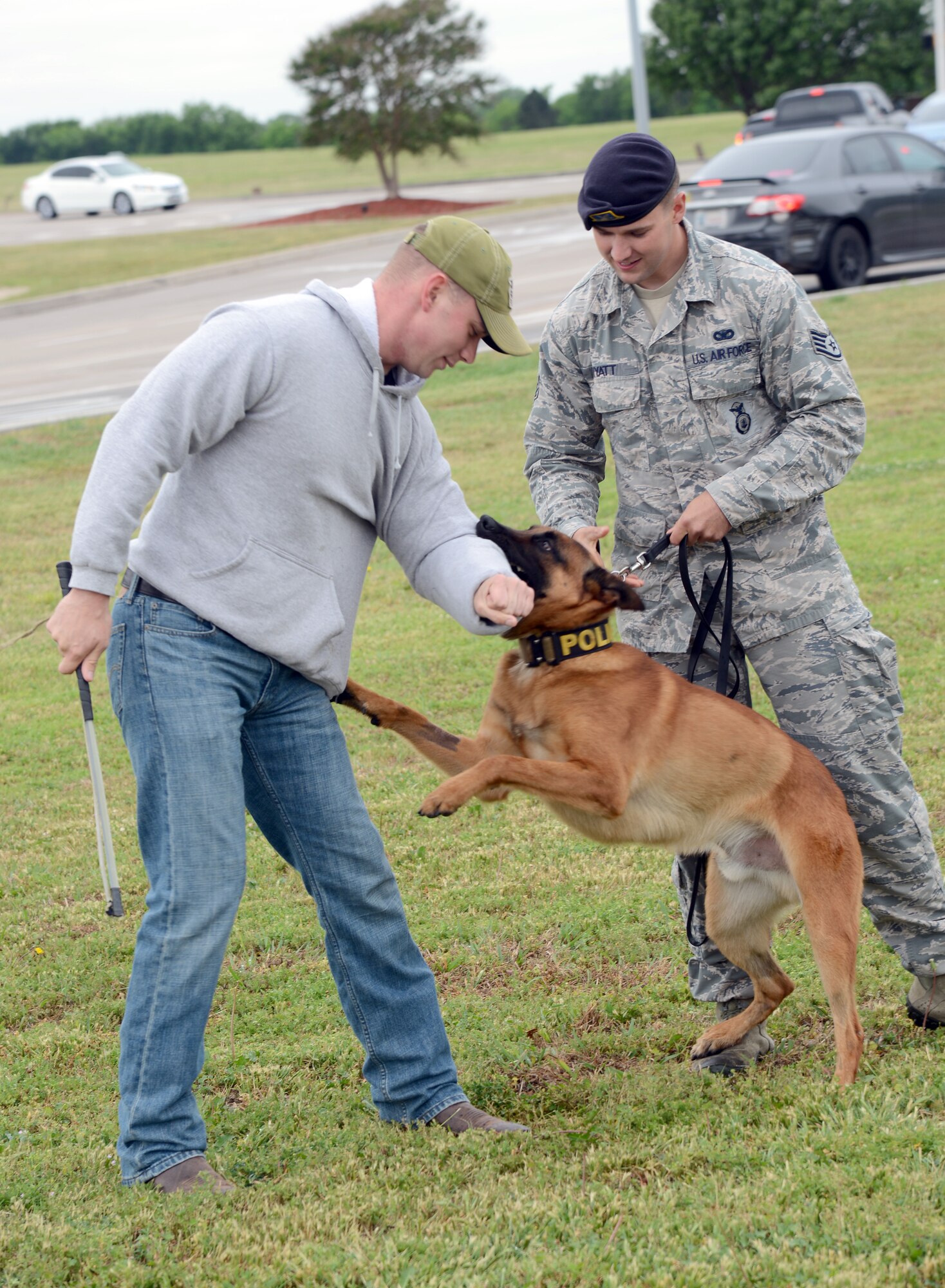 Military Working Dog Eelijah demonstrates how he can attack a person in plain clothes, Staff Sgt. Brett Jones, while still leashed to his handler, Staff Sgt. Cacy Wyatt, during a demonstration at the Tinker Exchange last week as part of National Police Week. (Air Force photos by Kelly White)
