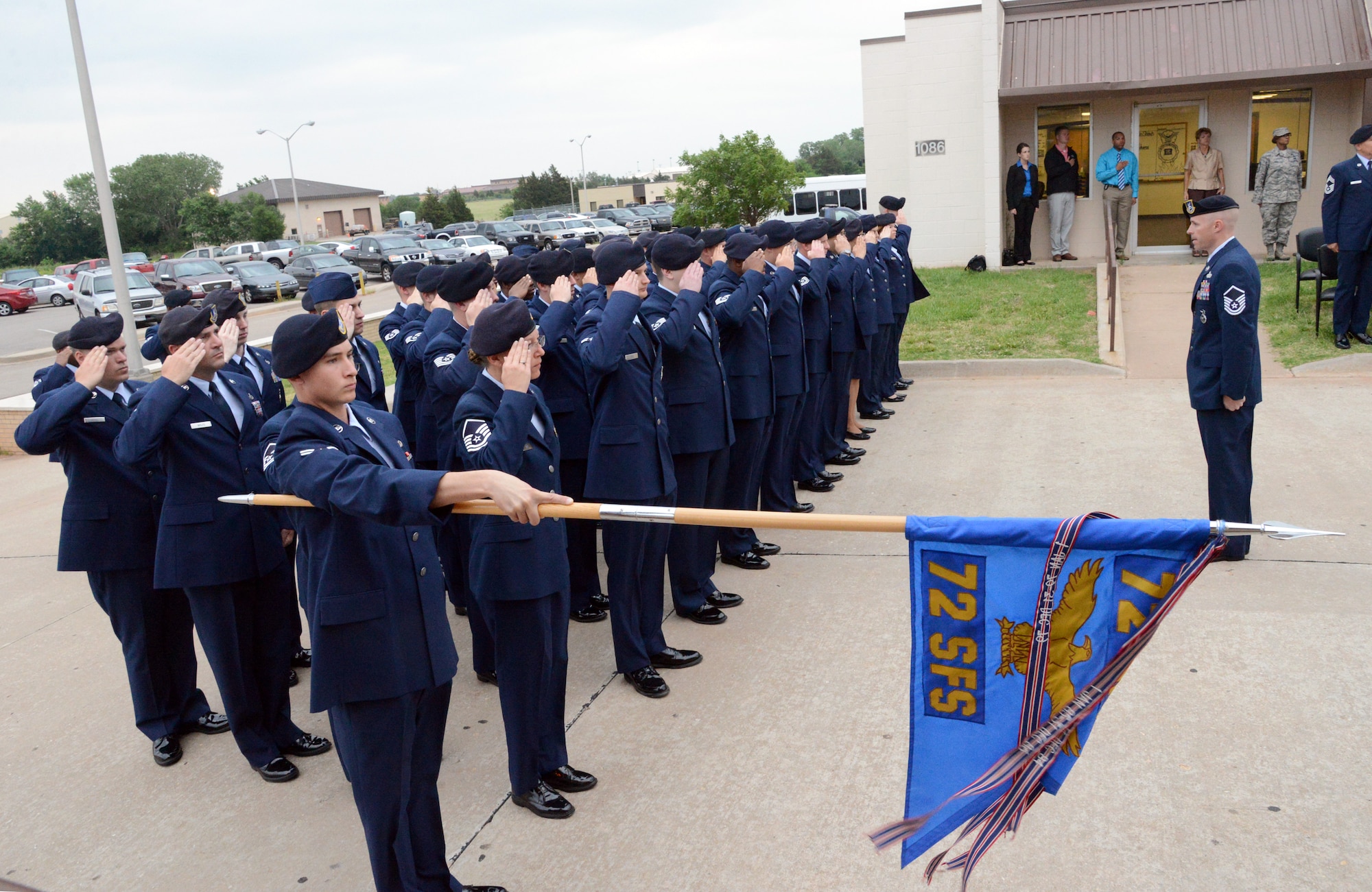 Members of the 72nd Security Forces Squadron stand in formation as the American flag is raised during a Reveille ceremony May 12, officially marking the beginning of National Police Week. The week falls whenever the 15th of May is, honoring fallen military and civilian police and first responders. (Air Force photo by Kelly White)