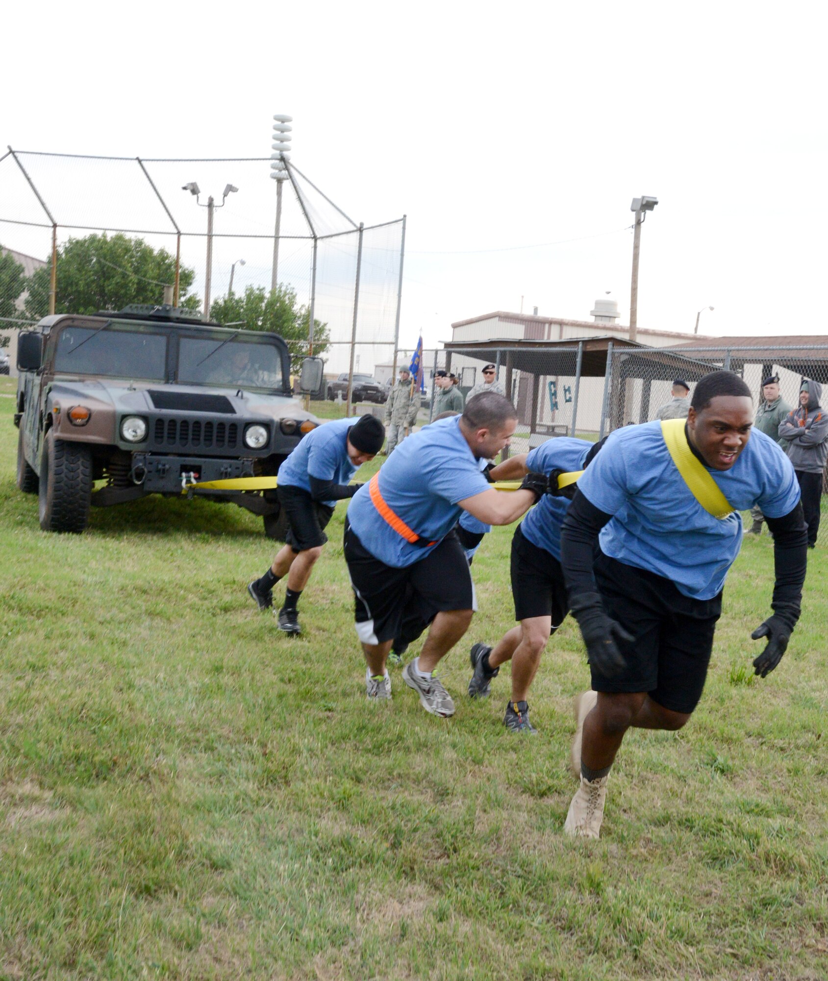 During last week's Police Week Games, several teams competed in a series of events focusing on strength and agility such as a tire flip, a push-up obstacle course, a Humvee pull, an ammo can dash and a water balloon sling. During the Humvee pull, team members had to physically pull a Humvee several yards, trying to finish with a faster time than the other teams. (Air Force photo by Kelly White)
