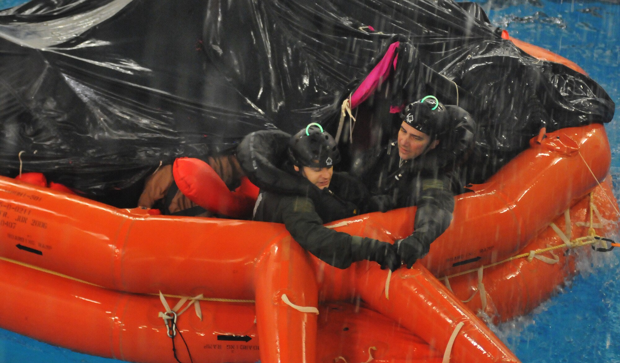 U.S. Air Force aircrew are subjected to torrential rain, 4-foot waves, simulated lightning and gale-force winds during an exercise in a water survival training course led by U.S. Air Force survival training experts at the Lowestoft College pool in Lowestoft, England, May 22, 2014. The class prepared aircrew for dangerous environments created by harsh weather conditions over water. The 48th Fighter Wing’s strategic, European-based location enables the unit to support U.S. Air Forces in Europe’s “Forward, Ready, Now” posture by providing worldwide, responsive, combat airpower. (U.S. Air Force photo by Staff Sgt. Thomas Trower/Released)