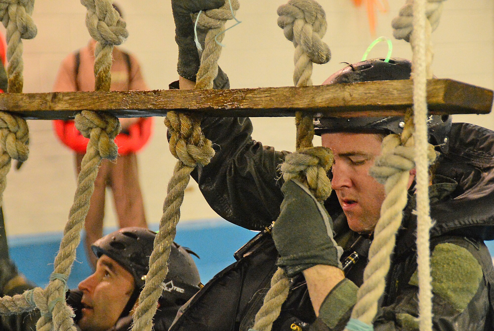 U.S. Air Force aircrew climb a recovery net during a water survival training course led by Air Force survival training experts at the Lowestoft College pool in Lowestoft, England, May 22, 2014. The class is mandatory for aircrew operating over water. Harsh sea conditions off the coast of England present a major danger and can force pilots to adjust training flights to take place over land. Ultimately, this shift may lead to increased aircraft noise heard by U.K. communities. (U.S. Air Force photo by Airman 1st Class Erin O’Shea/Released)