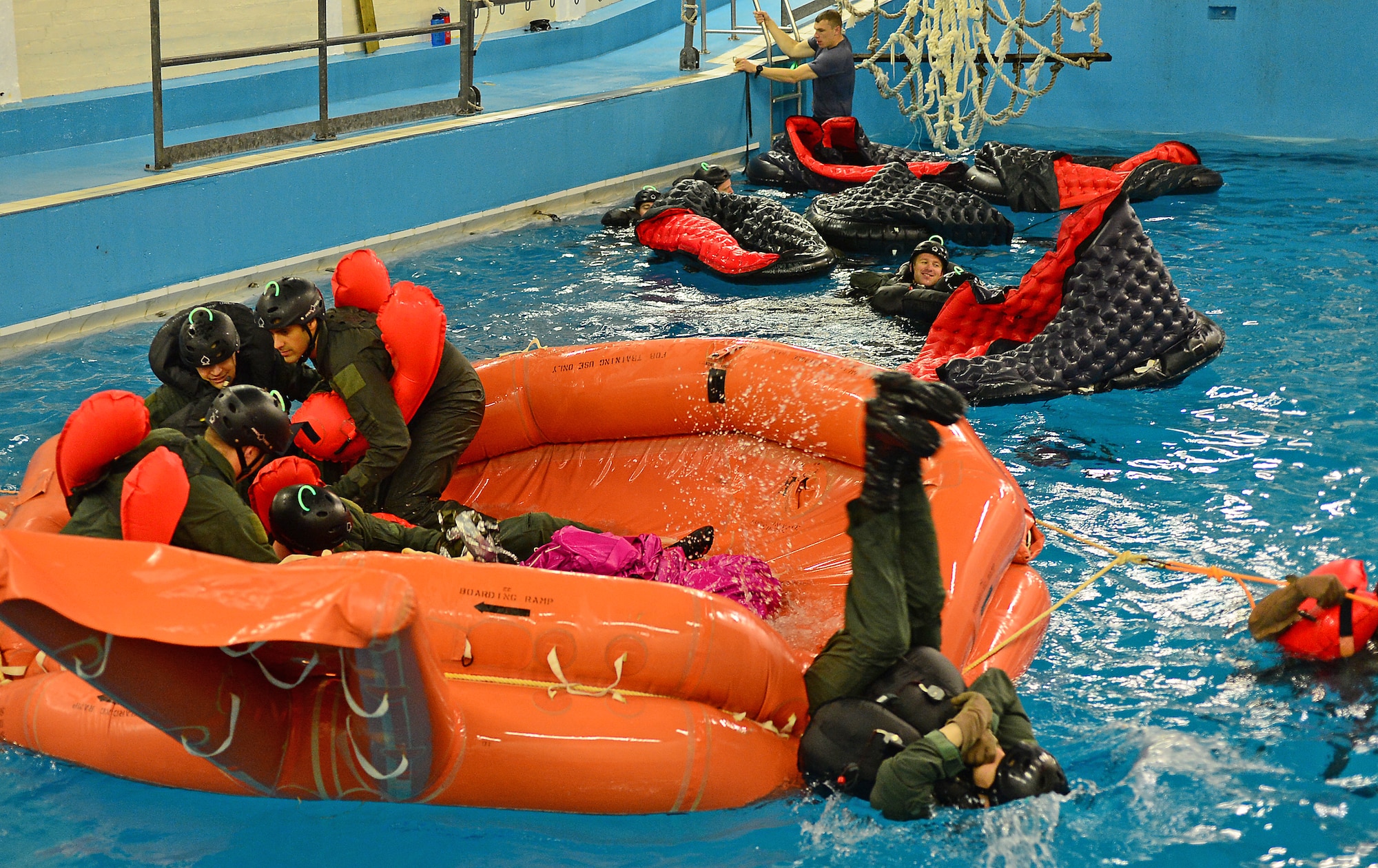 Fighter, air refueling and special operations aircrew participate in water survival training led by U.S. Air Force survival training experts at the Lowestoft College pool in Lowestoft, England, May 22, 2014. The class is mandatory for aircrew operating over a body of water. Harsh sea conditions off the coast of England present a major danger and can force pilots to adjust training flights to take place in airspace over land. Ultimately, this shift may lead to increased aircraft noise heard by U.K. communities. (U.S. Air Force photo by Airman 1st Class Erin O’Shea/Released)
