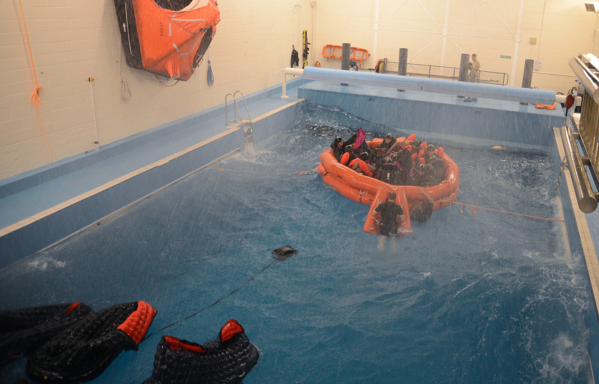 Fighter, air refueling and special operations aircrew participate in a water survival training course led by U.S. Air Force survival training experts at the Lowestoft College pool in Lowestoft, England, May 22, 2014. The class is mandatory for aircrew operating over a body of water. Harsh sea conditions off the coast of England present a major danger and can force pilots to adjust training flights to take place over land. Ultimately, this shift may lead to increased aircraft noise heard by U.K. communities. (U.S. Air Force photo by Staff Sgt. Thomas Trower/Released)