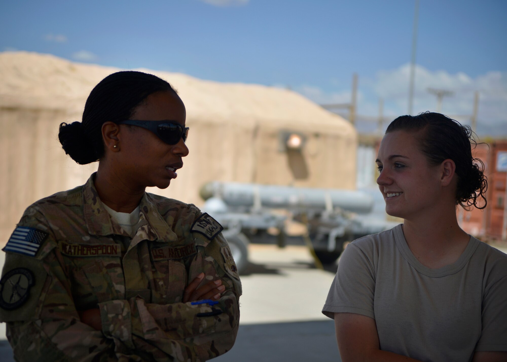 Senior Master Sgt. Gloria Weatherspoon, 455th Expeditionary Maintenance Squadron first sergeant, speaks with Airman First Class Casey Cain, 455th EMXS munitions specialist May 21, 2014 at Bagram Airfield, Afghanistan.  As a first sergeant, Weatherspoon takes care of Airmen’s needs and reports to the unit commander on matters that can affect welfare, morale and conduct.  Weatherspoon is deployed from Travis Air Force Base, Calif. and a native of Philadelphia, Pa. Cain is deployed from Whiteman Air Force Base, Mo. and a native of Unionville, Mo. (U.S. Air Force photo by Staff Sgt. Evelyn Chavez/Released)