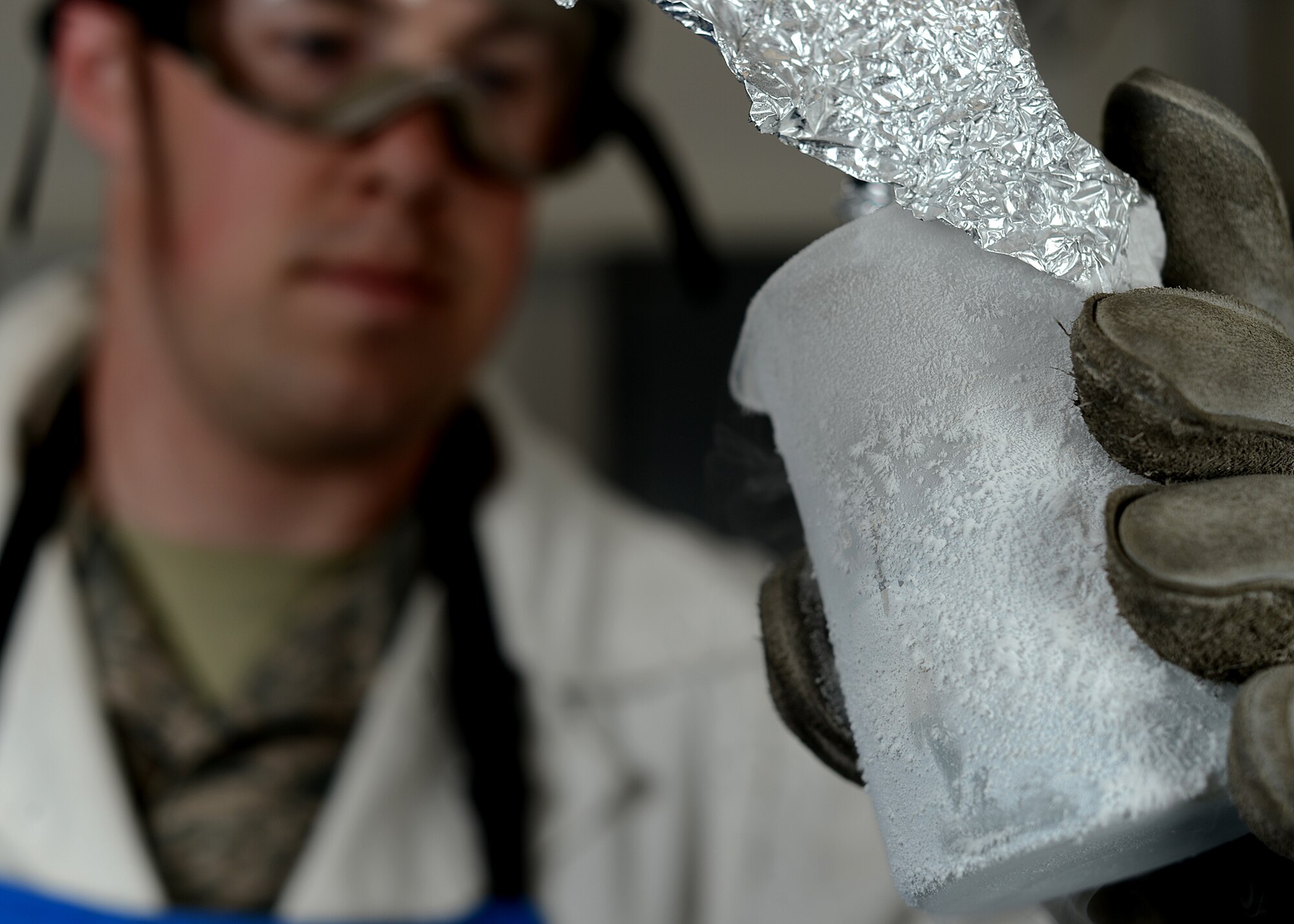 U.S. Air Force Staff Sgt. Kevin Moore, a 52nd Logistics Readiness Squadron cryogenics storage supervisor from Monroe, Mich., performs a sniff test on liquid oxygen at Spangdahlem Air Base, Germany, May 23, 2014. A sniff test was performed to detect odor. If an odor is present, the purity level of the oxygen may be low or it could be contaminated. (U.S. Air Force photo by Airman 1st Class Kyle Gese/Released)