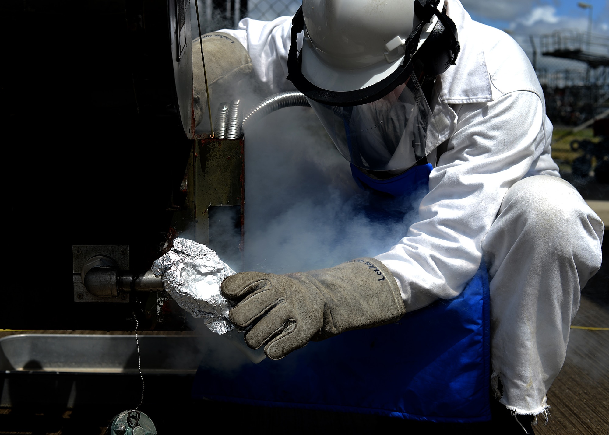 U.S. Air Force Staff Sgt. Kevin Moore, a 52nd Logistics Readiness Squadron cryogenics storage supervisor from Monroe, Mich., takes a sample of liquid oxygen at Spangdahlem Air Base, Germany, May 23, 2014. Liquid oxygen is used in aircraft that cannot self-produce oxygen. The substance then supplies the pilots and aircrew with breathable air. (U.S. Air Force photo by Airman 1st Class Kyle Gese/Released)
