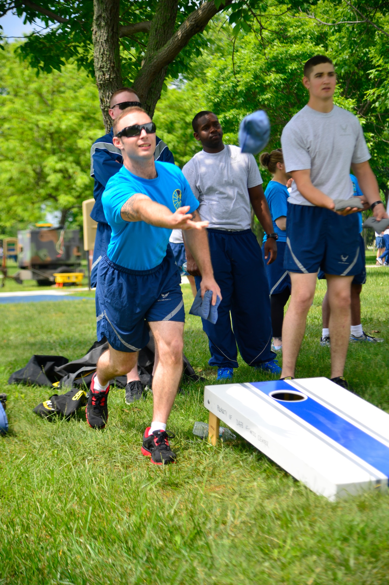 Senior Airman Thomas Witt, 436 Force Support Squadron, throws a cornhole bag during Wingman Day May 22, 2014, at the Eagles Nest Park on Dover Air Force Base, Del. There were 64 two-person teams that participated in the cornhole event. (U.S. Air Force photo/Airman 1st Class William Johnson)