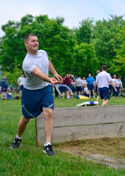 Staff Sgt. Caleb Dubourg, 436th Maintenance Squadron, throws a horseshoe during Wingman Day May 22, 2014, at the Eagles Nest Park on Dover Air Force Base, Del. Team Dover held a variety of team building events and sports to build morale and highlight all of the aspects of Airmen comprehensive fitness. (U.S. Air Force photo/Airman 1st Class William Johnson)