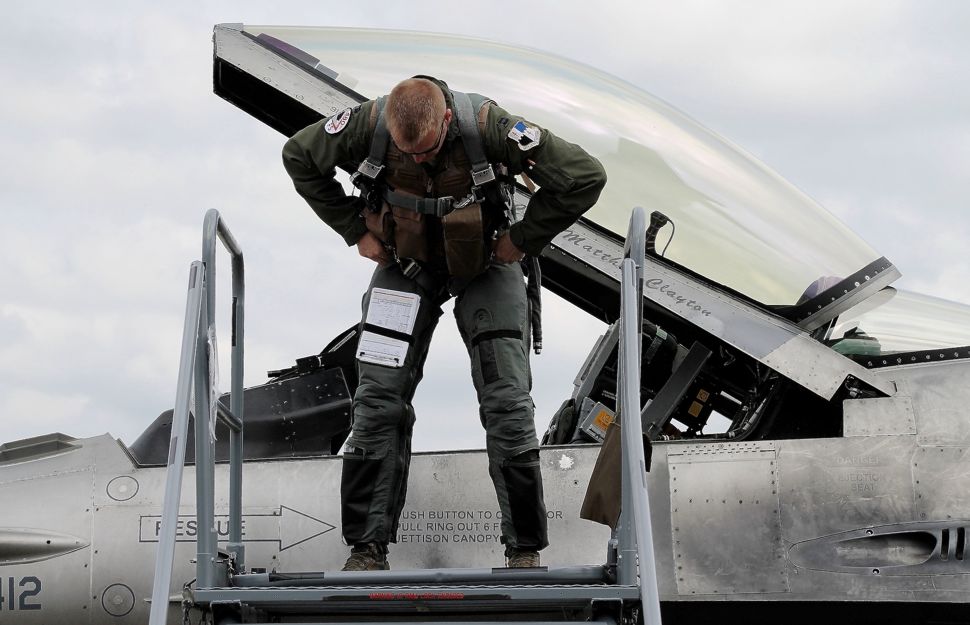 U.S. Air Force Capt. Casey Manning, F-16 Fighting Falcon fighter aircraft pilot from Spangdahlem Air Base, Germany, performs post-flight procedures shortly after arriving at this year’s Berlin Trade and Air Show, Berlin, May 20, 2014. The U.S. aircraft on the ramp were open for spectators and vendors within the aerospace industry to observe and interact with all crew members who not only operate the aircraft, but also maintain them. (U.S. Air Force photo by 2nd Lt. Clay Lancaster/Released)