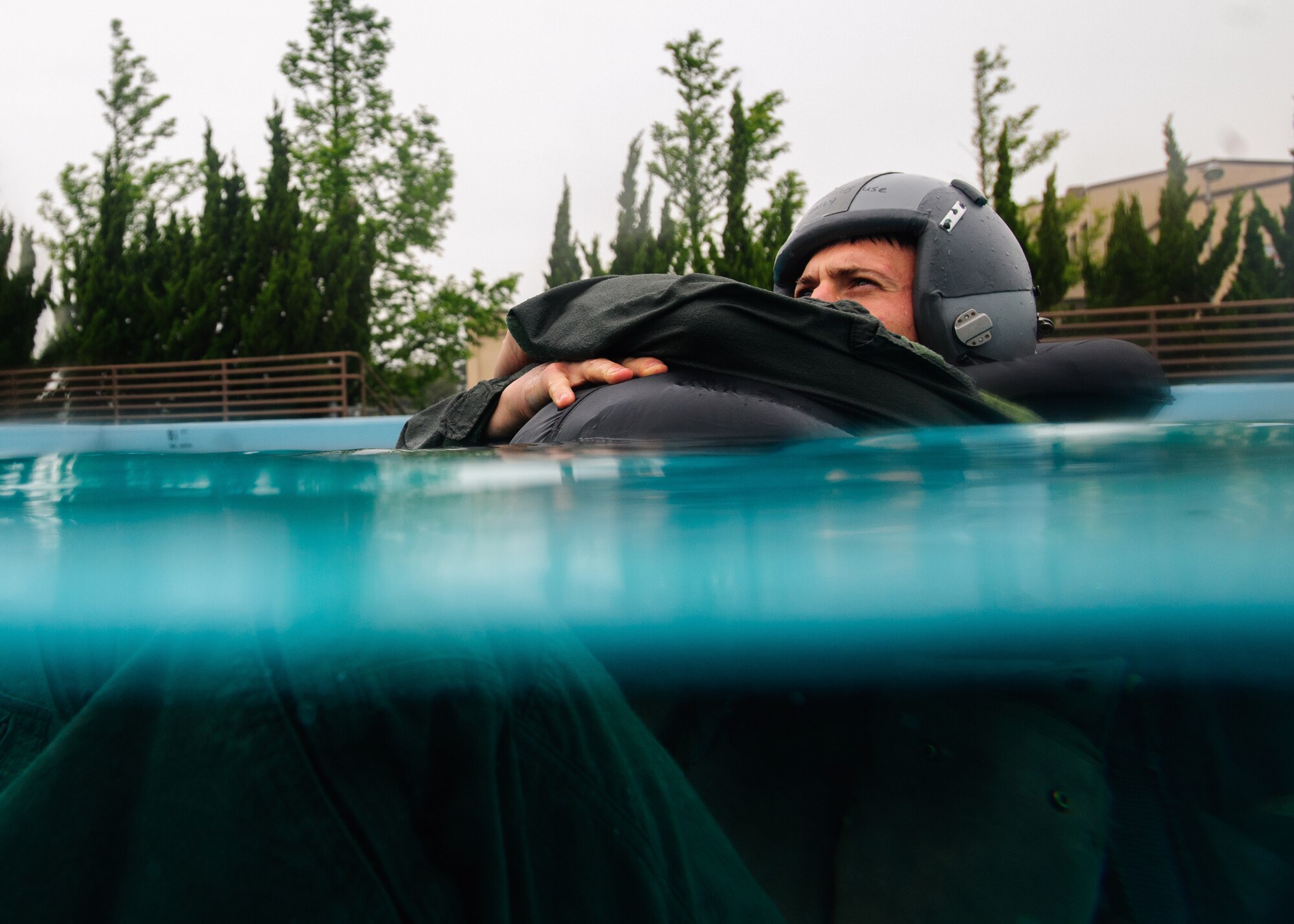 Tech. Sgt. Kurtis Douge, 8th Operations Support Squadron survival, evasion, resistance and escape specialist and weapons and tactics NCO in charge, demonstrates how to stay warm after ejecting and landing in water at Kunsan Air Base, Republic of Korea, May 20, 2014. Douge and the SERE team hosted the Republic of Korea SERE instructors to share knowledge on water survival training for pilots from both nations. (U.S. Air Force photo by Senior Airman Armando A. Schwier-Morales/Released)