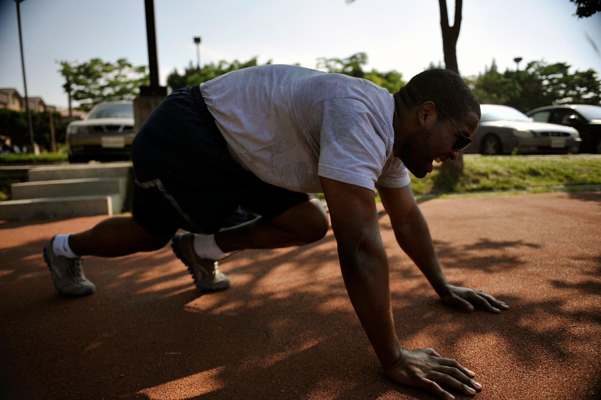 Staff Sgt. Albert Banks, 51st Munitions Squadron, performs mountain climbers during the Evolution 2 Excellence program May 21, on Osan Air Base, Republic of Korea. The participants also ran 2.8 miles during this session. (U.S. Air Force photo by Senior Airman David Owsianka)