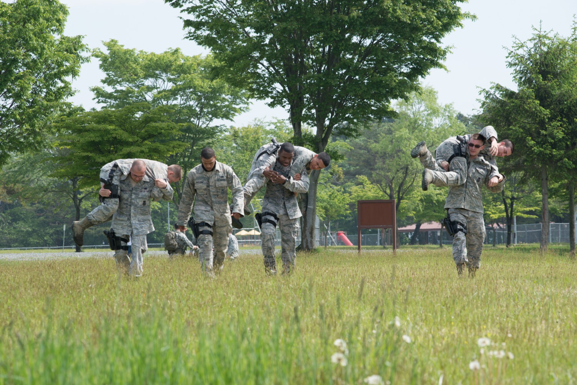 U.S. Air Force members of the 35th Security Forces Squadron execute buddy carries during a Special Reaction Team training day at Misawa Air Base, Japan, May 27, 2014. Eight Airmen tried out to become SRT members and were put through various physically and mentally taxing exercises before earning their SRT patch. (U.S. Air Force photo/Staff Sgt. Jared Elliott)