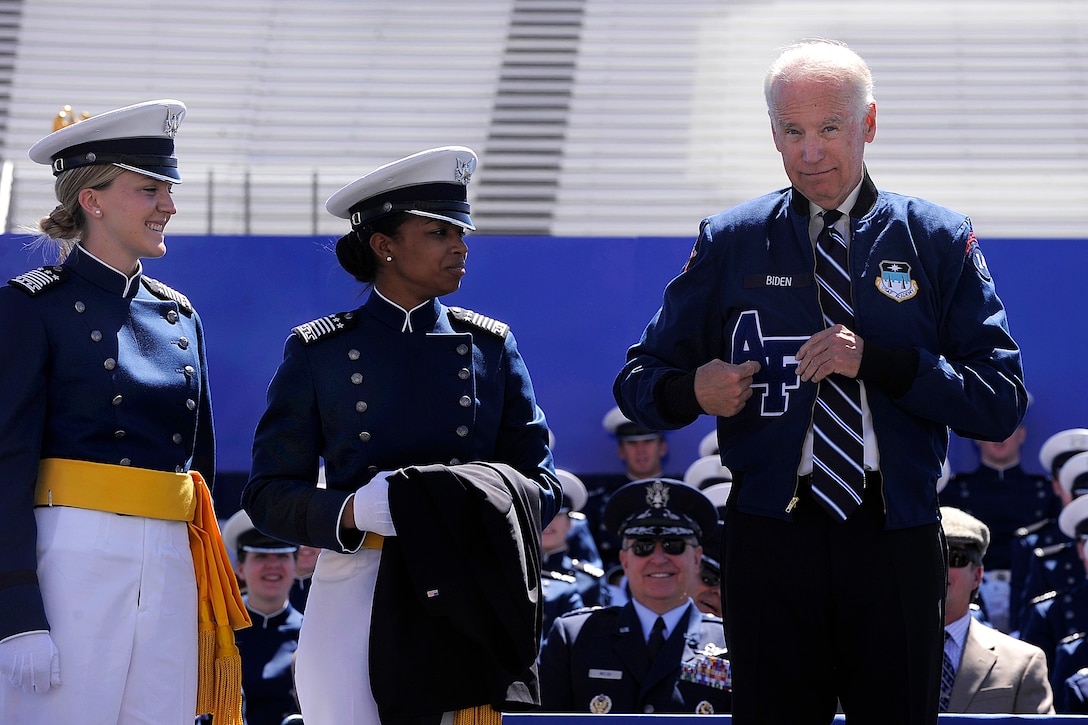 Vice President Joe Biden receives an athletic jacket from the U.S. Air Force Academy Class of 2014 during commencement ceremony at Falcon Stadium in Colorado Springs, Colo., May 28, 2014.