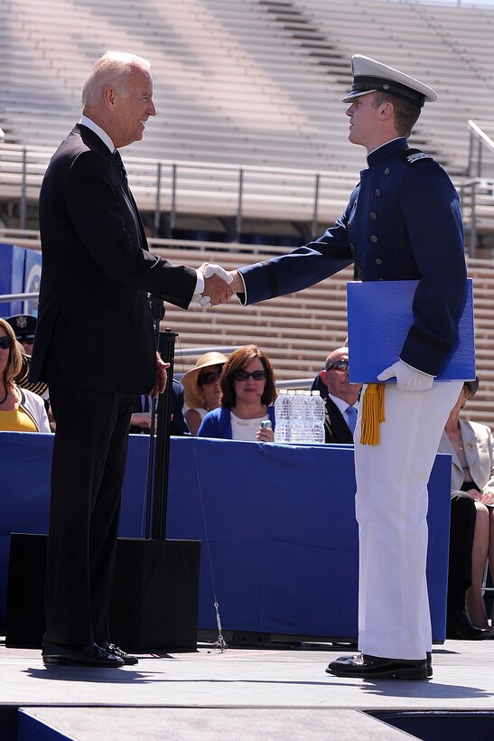 Vice President Joe Biden congratulates Cadet Senior David McCarthy as the top graduate of the U.S. Air Force Academy's Class of 2014 during the commencement ceremony at Falcon Stadium in Colorado Springs, Colo., May 28, 2014.