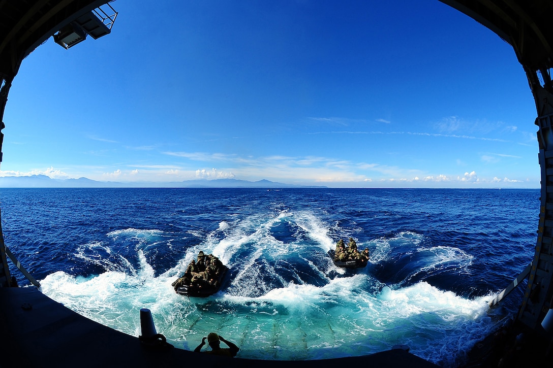 Marines approach the well deck of amphibious dock landing ship USS Tortuga after conducting open ocean operations using combat rubber crafts in Okinawa, Japan, Aug. 25, 2012. The Tortuga is apart of the only forward-deployed amphibious ready group. The Marines are assigned to the 31st Marine Expeditionary Unit. 

