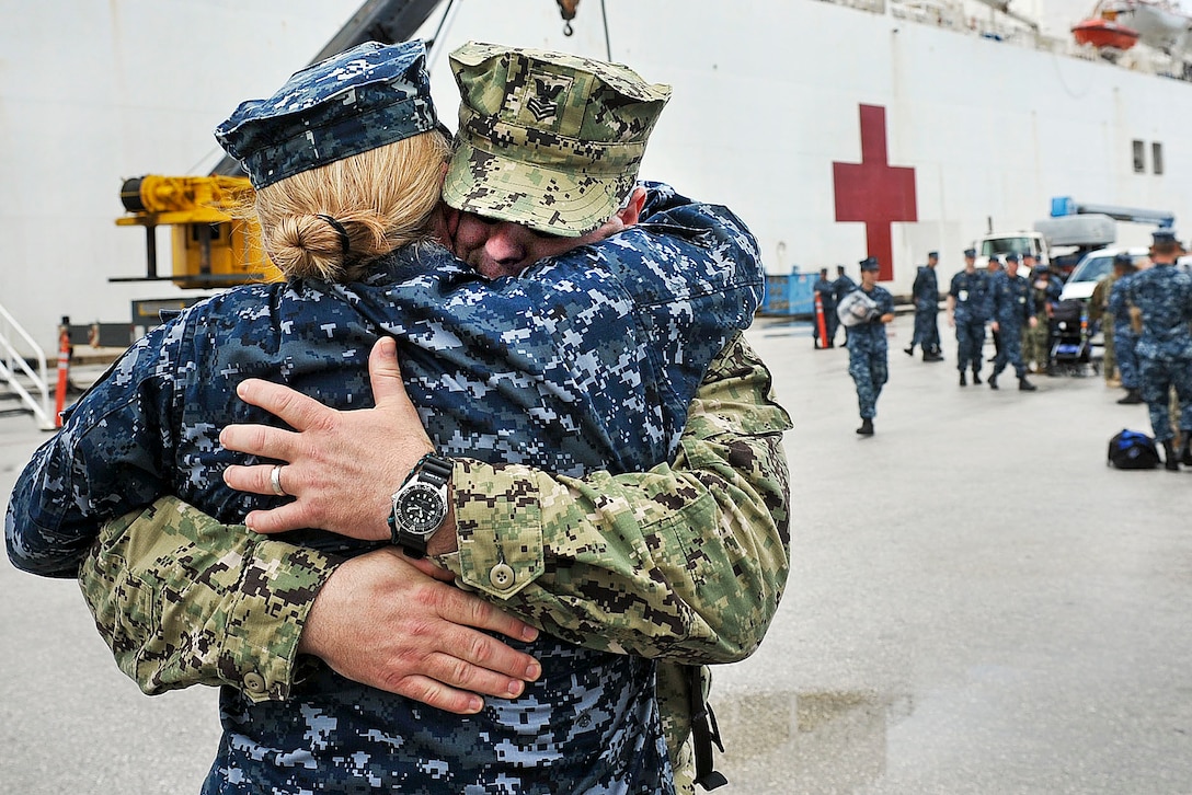 Navy Petty Officer 1st Class Michael Cowan greets his his wife, Senior Chief Shannon Cowan, after his return to Guam, Aug. 20, 2012, from a four-and-a-half month humanitarian assistance mission in Southeast Asia aboard the Military Sealift Command hospital ship USNS Mercy. The Mercy participated in Pacific Partnership 2012, the largest annual humanitarian and civic action mission in the Asia-Pacific region.  
