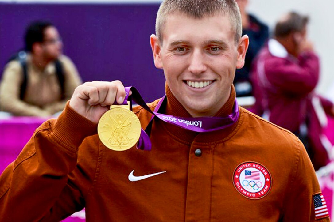 U.S. Army World Class Athlete Program rifle shooter Sgt. Vincent Hancock proudly displays his Olympic gold medal after winning the shooting competition in men’s skeet at the Royal Artillery Barracks during the 2012 Summer Olympic Games in London, July 31, 2012. He earned a gold medal in the same event in the 2008 Summer Olympic Games in Beijing, and with this year's victory became the first shooter to win back-to-back gold medals in the sport.  
