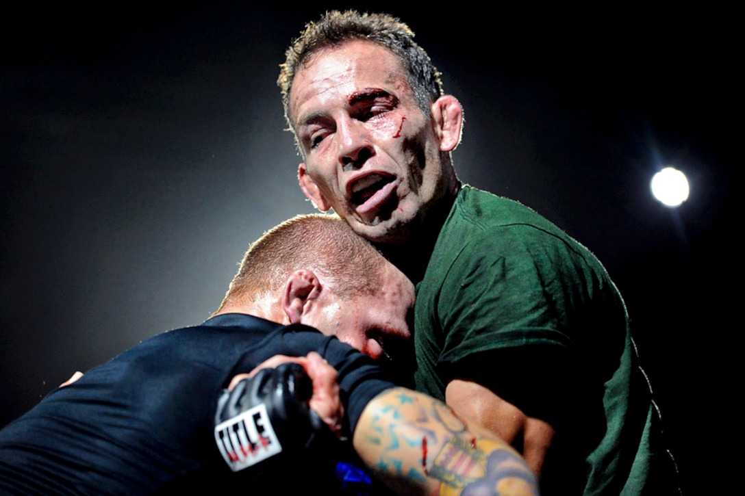 Army Staff Sgt. Glenn Garrison, right, and Army Staff Sgt. Shane Lees grapple during the finals of the lightweight division of the 2012 U.S. Army Combatives Championship on Fort Hood, Texas, July 28, 2012. Garrison, who won the match, is assigned to Fort Carson, Colo.  

