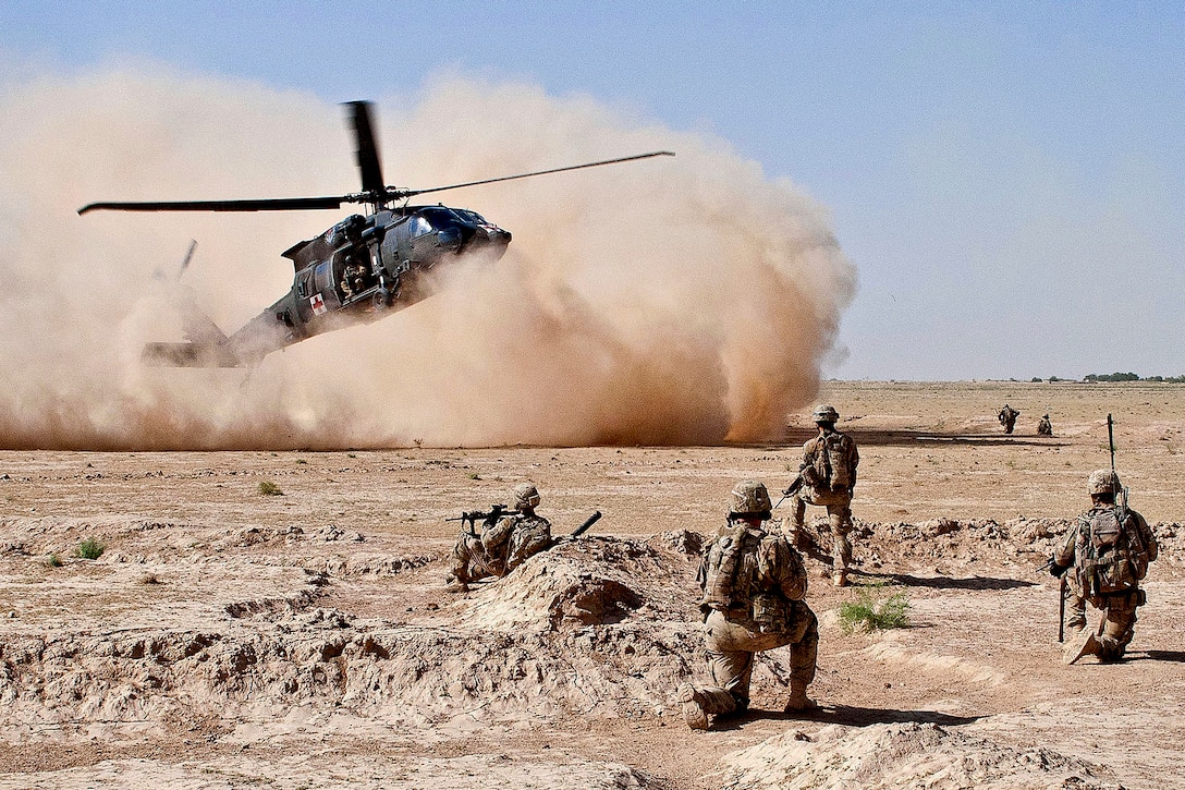 A UH-60 Black Hawk medical evacuation helicopter lands as U.S. Army paratroopers secure the area in Afghanistan's Ghazni province, July 23, 2012. The soldiers are assigned to the 82nd Airborne Division’s 1st Brigade Combat Team and the helicopter crew is assigned to the 82nd Combat Aviation Brigade. The soldiers evacuated a wounded insurgent. 
