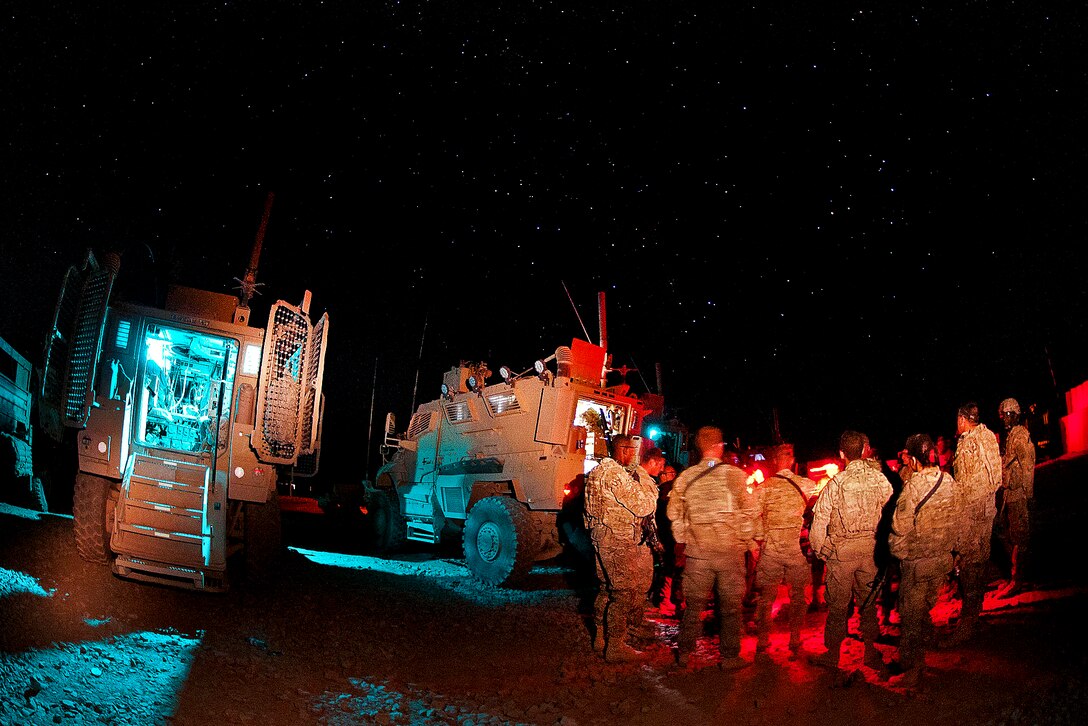 U.S. paratroopers gather for a mission brief before the return leg of a resupply convoy on Forward Operating Base Arian in Afghanistan's Ghazni province, July 9, 2012.  

