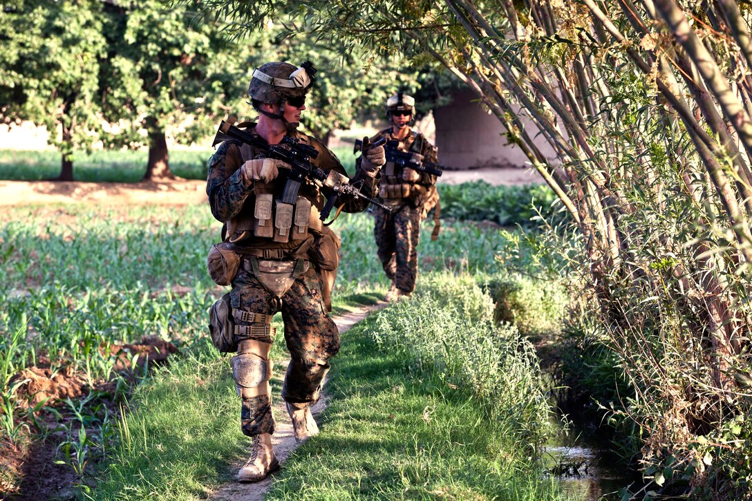 U.S. Navy Seaman Derek Happel, front, and U.S. Marine Corps Cpl. Alexander Vanny patrol in Sangin in Afghanistan's Helmand province, July 11, 2012. Happel, a hospitalman, and Vanny, a team leader, are assigned to Alpha Company, 1st Battalion, 7th Marine Regiment, Regimental Combat Team 6. The Marines conducted the patrol to support Afghan forces during Operation Gospand-Sia.  
