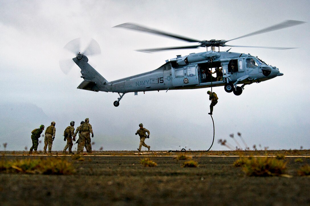 U.S., Australian and Canadian sailors fast rope out of a U.S. Navy MH-60S Nighthawk helicopter from Helicopter Sea Combat Squadron 4 during Rim of the Pacific 2012, an international maritime exercise, on Marine Corps Base Hawaii, Kaneohe Bay, July 16, 2012. Twenty-two nations, more than 40 ships and submarines, more than 200 aircraft and 25,000 people are participating in the exercise in and around Hawaii. 
