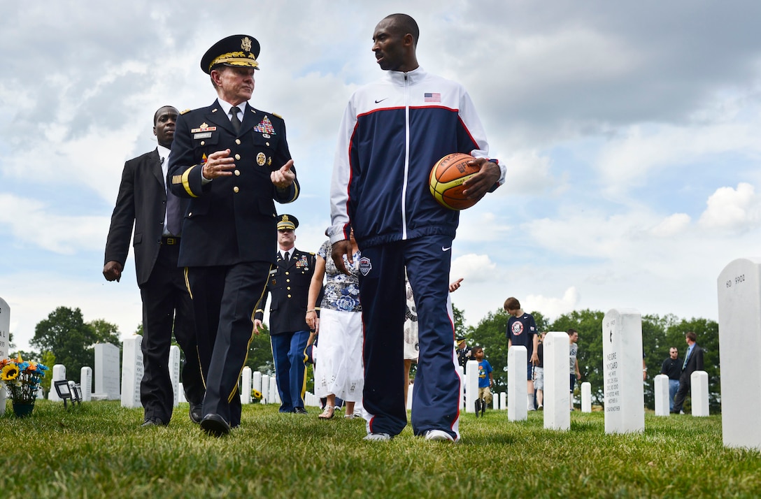 Army Gen. Martin E. Dempsey, chairman of the Joint Chiefs of Staff, walks with professional basketball player Kobe Bryant at Arlington National Cemetery, Arlington, Va., July 15, 2012. Bryant, a member of the Los Angeles Lakers, will play on the USA Olympic basketball team in London.  
