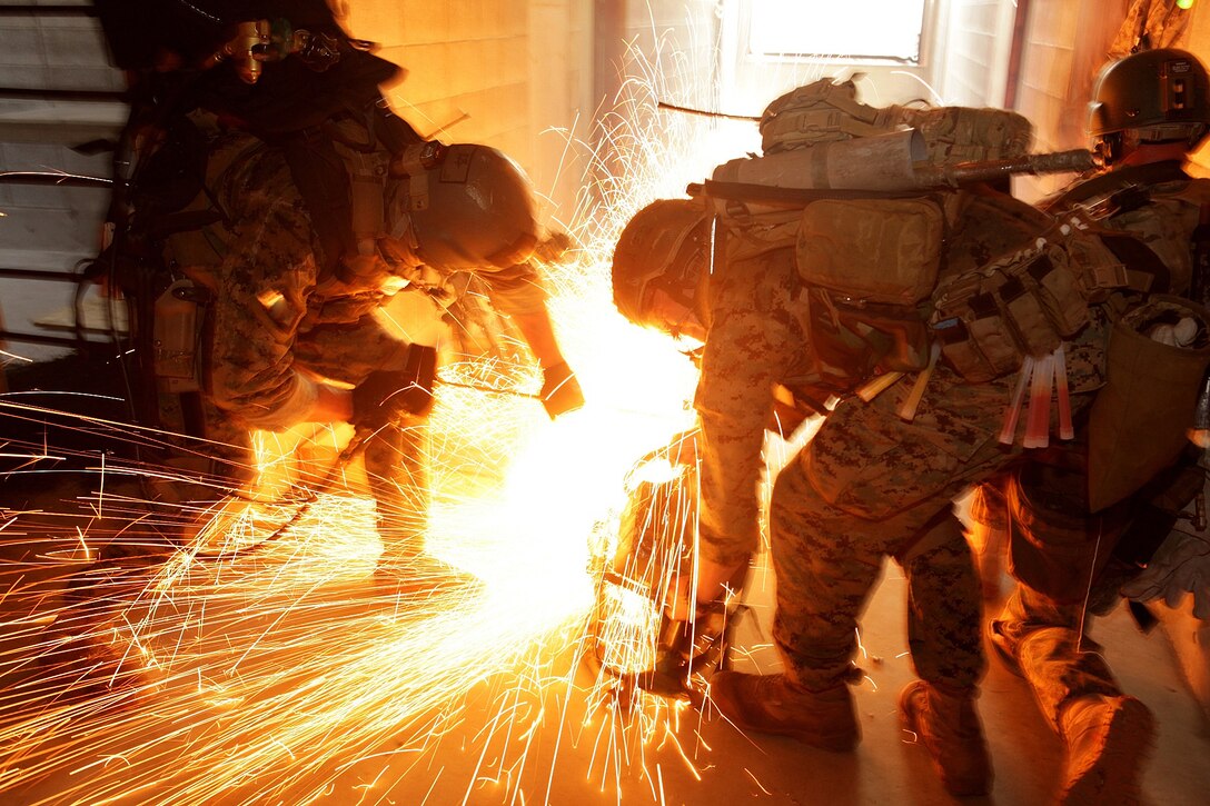 U.S. Marines use a circular saw to ignite a Brocos torch while attempting to breach steel barricades during a training exercise on Camp Fuji, Shizouka, Japan, July 9, 2012. The Marines are assigned to 31st Marine Expeditionary Unit's Maritime Raid Force.  
