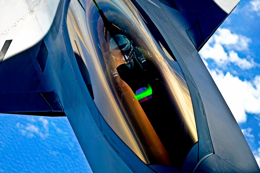 An Air Force pilot mans the controls of an F-22 Raptor as it receives fuel from a KC-135 Stratotanker over the Atlantic Ocean, July 10, 2012.  
