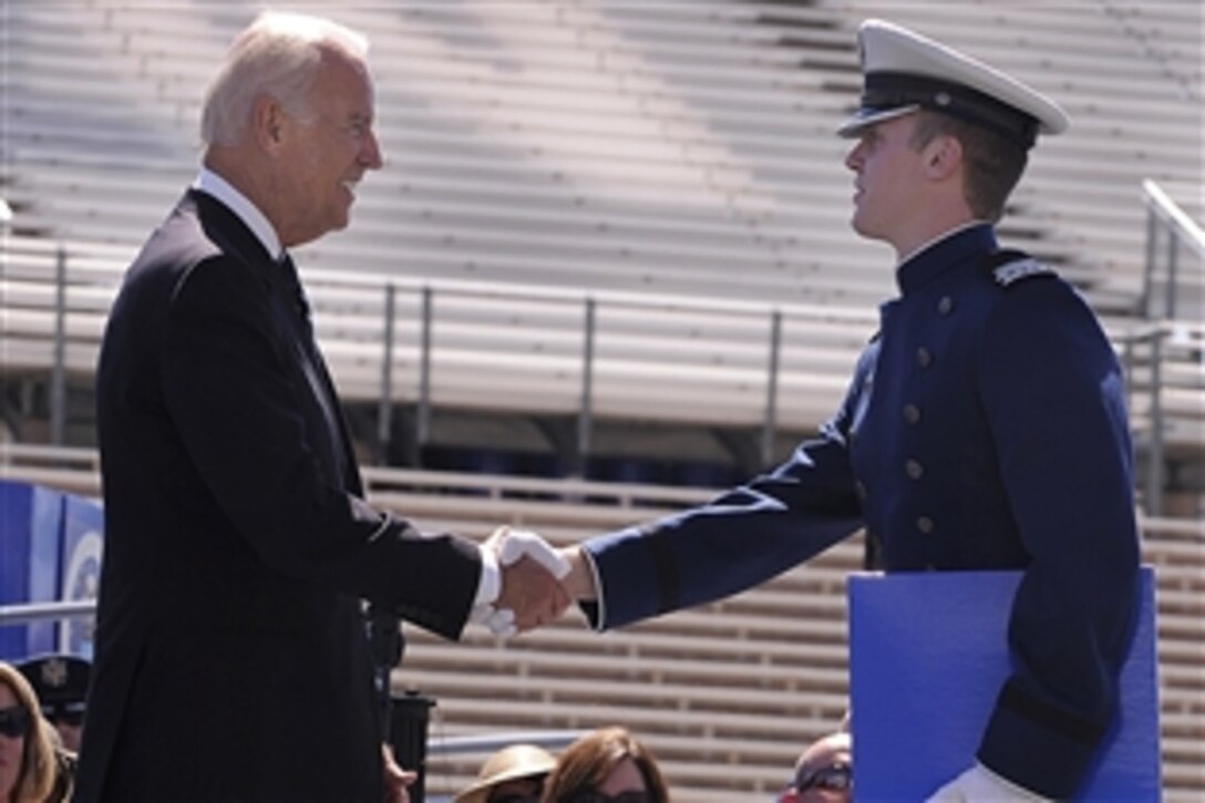 Vice President Joe Biden shakes hands with a graduating cadet after delivering the commencement address at the U.S. Air Force Academy in Colorado Springs, Colo., May 28, 2014. 