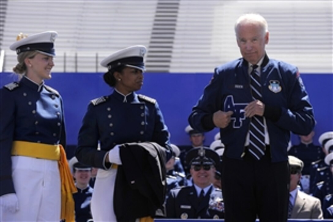 Vice President Joe Biden receives an athletic jacket as a gift from the U.S. Air Force Academy Class of 2014 during commencement ceremony at Falcon Stadium in Colorado Springs, Colo., May 28, 2014. Biden delivered the commencement address. 