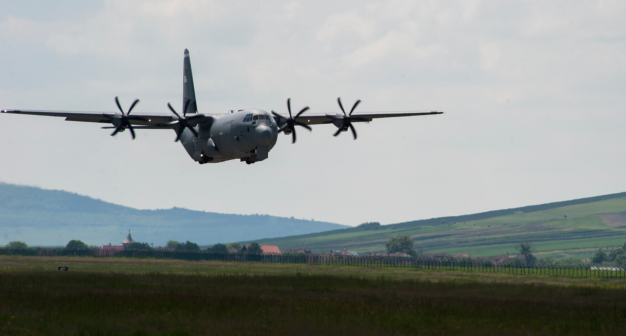 A C-130J Super Hercules from the 37th Airlift Squadron performs a touch and go during Carpathian Spring 2014, May 18, 2014, Campia Turzii, Romania. During the two-week-long training, pilots were able to utilize the less restrictive airspace, allowing them to perform low-level and night vision flights. (U.S. Air Force photo/Senior Airman Damon Kasberg)