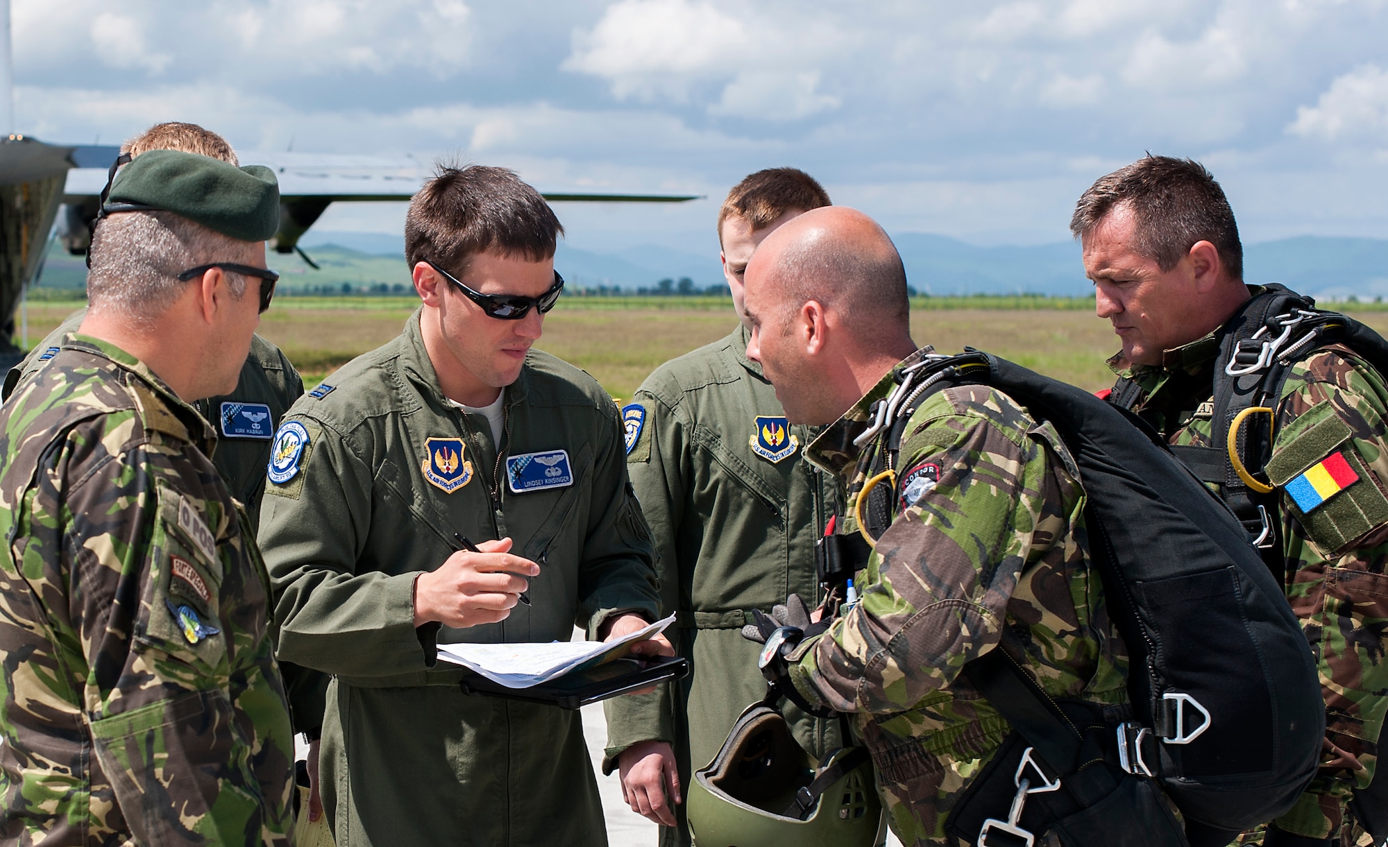Members of the 37th Airlift Squadron and the Romanian air force coordinate jump procedures May 18, 2014, at Campia Turzii, Romania. The-two-week long training allowed the C-130J Super Hercules aircrew to fly in less restrictive airspace, letting them utilize night vision capabilities and fly in low level formations. (U.S. Air Force photo/Senior Airman Damon Kasberg)