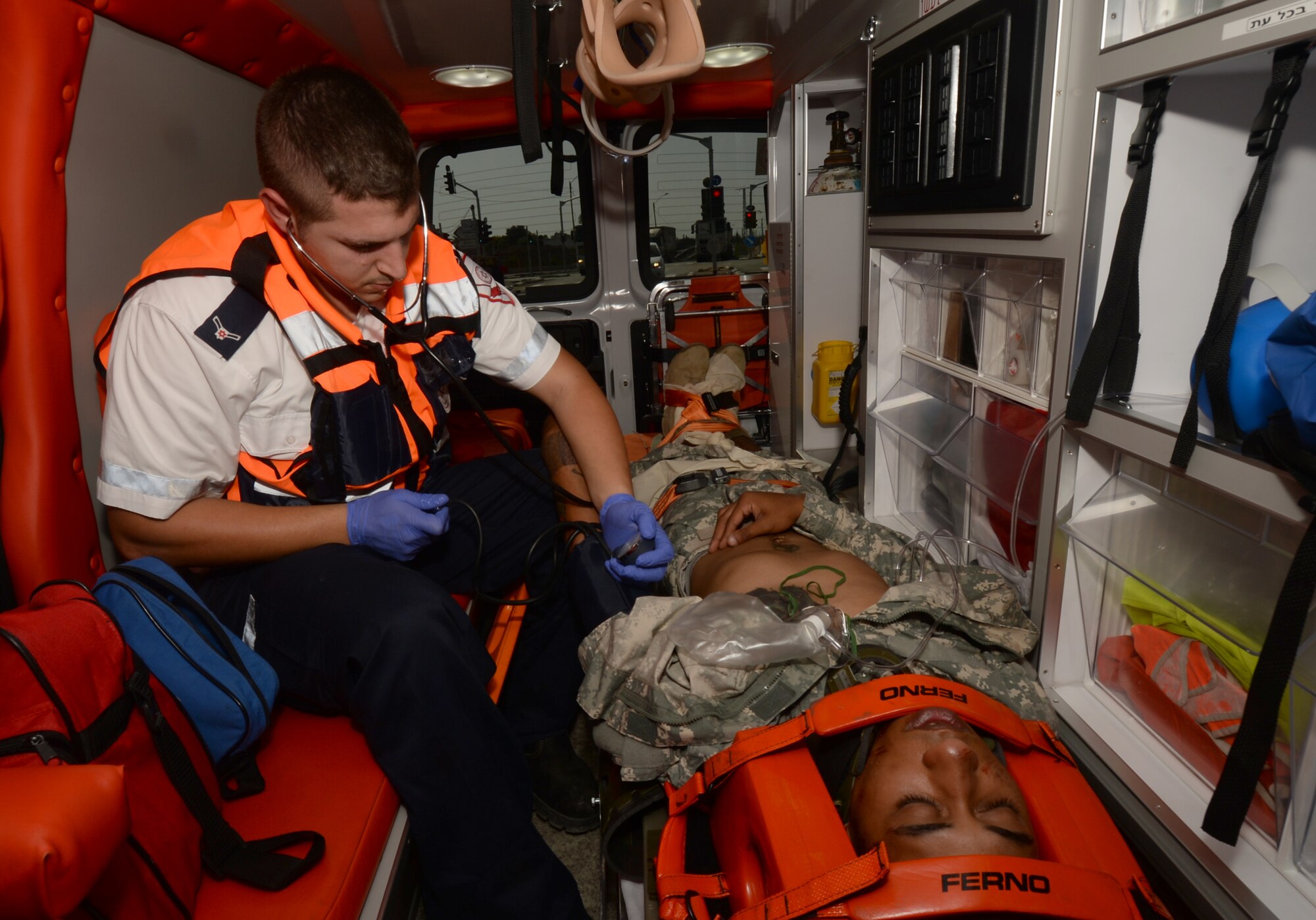 Chen Michael tends to Army Private 1st Class James Black and Atlanta native, while on-board an ambulance during a simulated medical evacuation May 20, 2014, as part of the Juniper Cobra 14 defense training exercise in Israel. Michael is a Magen David Adom medic. Black is a multi-channel radio operator maintainer assigned to the 44th Signal Battalion at Grafenwoehr, Germany. (U.S. Air Force photo/Staff Sgt. Joe W. McFadden)