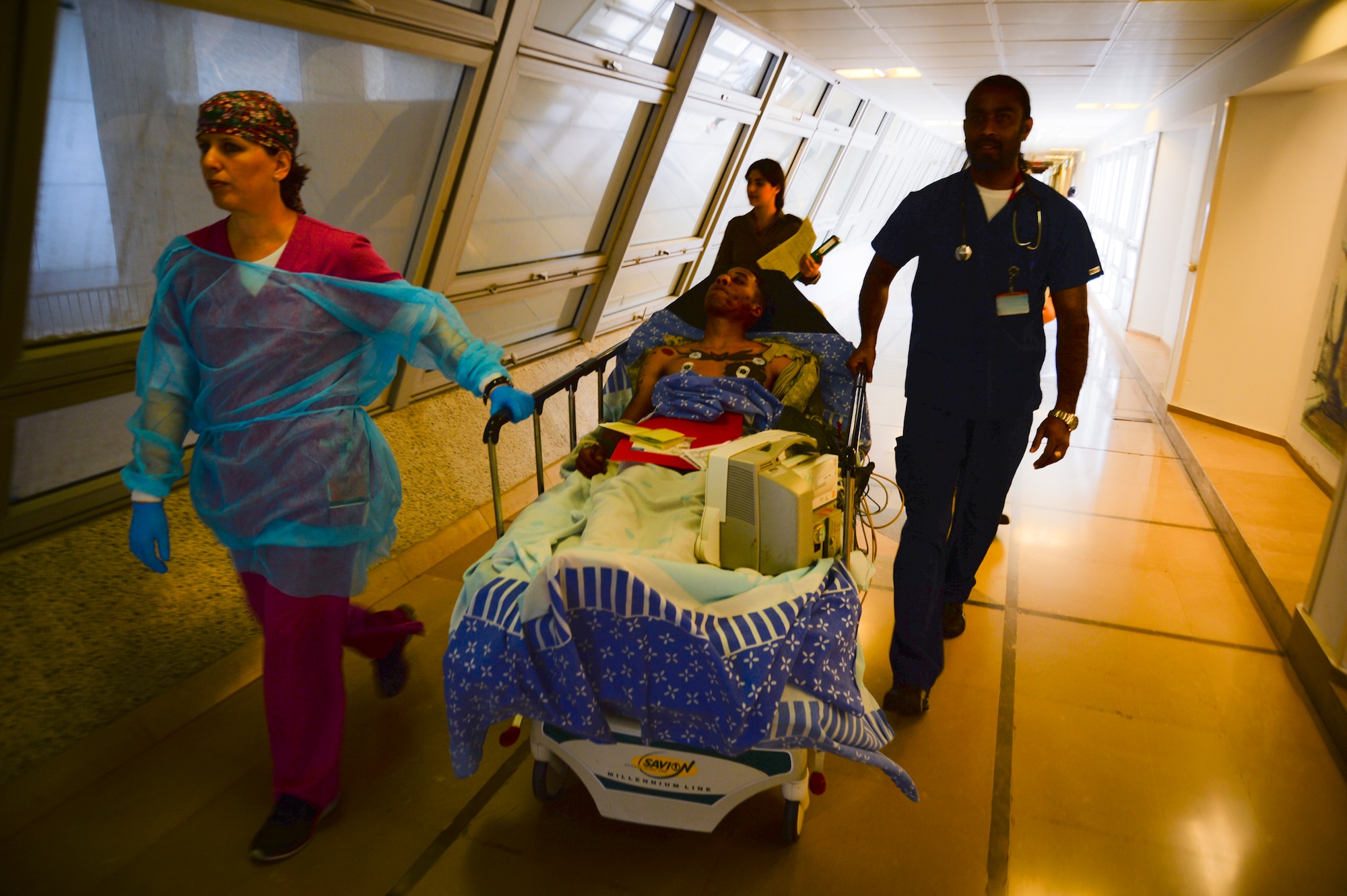 Israeli medics transport Army Private 1st Class James Black through a corridor during a simulated medical evacuation May 20, 2014, at Sheba Medical Center near Beer Sheba, Israel. The medical exercise tested both nations' ability to communicate and track transportation of a simulated patient from the scene of an injury, to a hospital, and then to a U.S. military aircraft. Black is a multi-channel radio operator maintainer assigned to the 44th Signal Battalion at Grafenwoehr, Germany. (U.S. Air Force photo illustration/Staff Sgt. Joe W. McFadden)