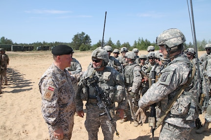Lt. Gen. Raimonds Graube, Latvia's chief of defense, speaks with U.S. Army paratroopers from 1st Battalion, 503rd Infantry Regiment, 173rd Airborne Brigade following a training exercise May 25, 2014, at Military Camp Adazi, Latvia. The paratroopers, based in Vicenza, Italy, are in Latvia conducting allied training exercises demonstrating the U.S. Army's ongoing commitment to its NATO allies.