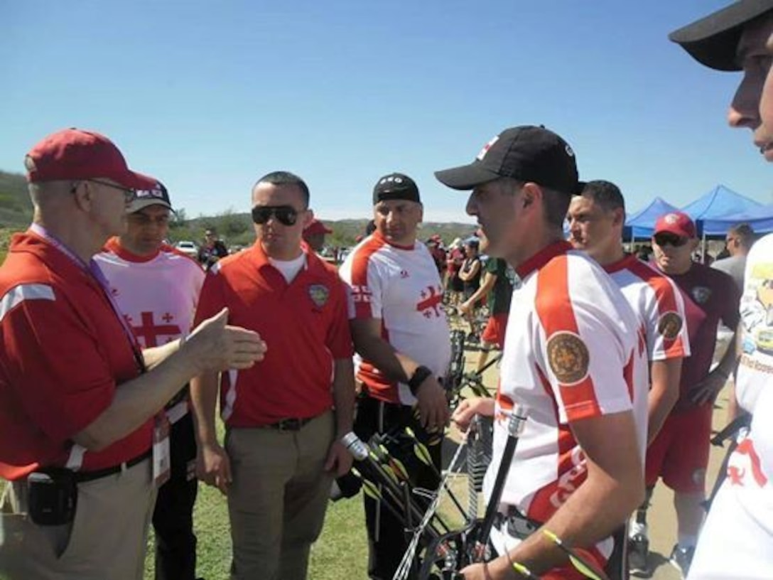 Cpl. Lasha Otiuridze (center red shirt) listens in on a discussion to translate for the Georgian team during the 2014 Marine Corps Trials, a paralympics event held at Marine Corps Base Camp Pendleton, Calif., March 4-12. Otiuridze served as a translator for the Georgian team throughout the games.


