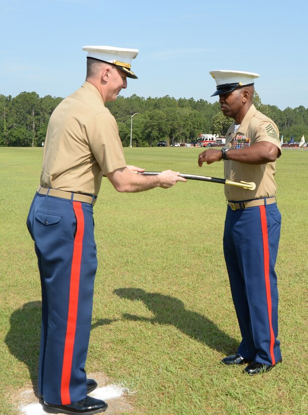 Col. Don Davis, commanding officer, Marine Corps Logistics Base Albany, transfers the noncommissioned officer’s sword to Sgt. Maj. Kenneth Agee, incoming sergeant major, MCLB Albany, during a Relief and Appointment Ceremony at Schmid Field, May 23.