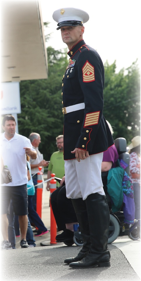 First Sergeant Edward Kretschmer, Headquarters Battalion
1st Sgt. and stableman on Marine Corps Logistics
Base Barstiow, Calif., stands and directs people during the
Pancake Breakfast in Redding Calif., May 16, 2014. Kretschmer
also presented the Nation’s Colors during every rodeo and
parade while in Redding.