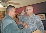 James Chandler, Nevada Army National Guard combat engineer with the 609th, is promoted to captain by Lt. Col. Wilson de Silva of the 17th Sustainment Brigade, Nevada Army National Guard. Chandler, who has terminal cancer, was surprised in his home for the ceremony.