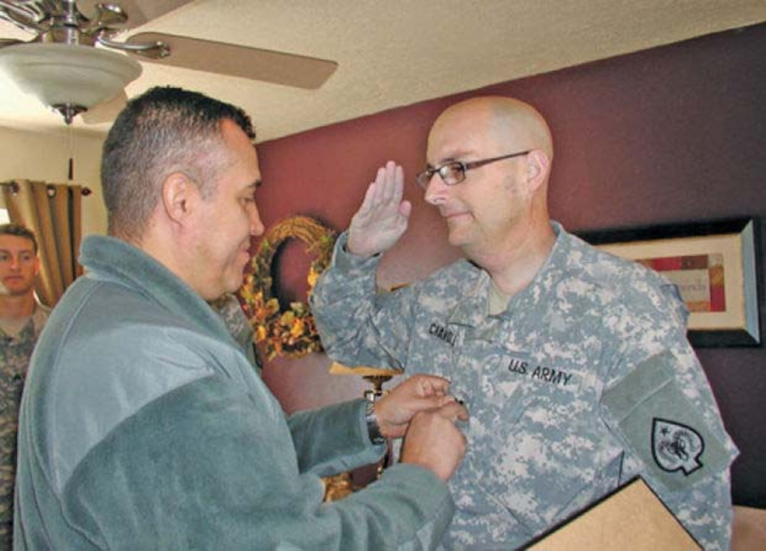 James Chandler, Nevada Army National Guard combat engineer with the 609th, is promoted to captain by Lt. Col. Wilson de Silva of the 17th Sustainment Brigade, Nevada Army National Guard. Chandler, who has terminal cancer, was surprised in his home for the ceremony.
