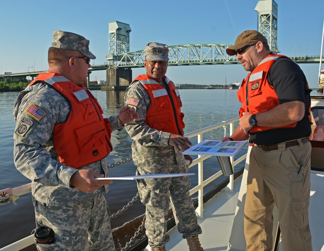 Wilmington District Commander Col. Steven Baker, left, and SAW Chief of Navigation Roger Bullock brief Chief of Engineers Lt. Gen. Thomas Bostick about the Wilmington District's navigation and dredging mission onboard the survey vessel BEAUFORT during a trip down the Cape Fear River on Tuesday, May 20. Lt. Gen. Bostick also got an up close look at the Wilmington District's unique shallowdraft dredging mission when he boarded the sidecast vessel MERRITT as it cleared the federal channel in Carolina Beach Inlet south of Wilmington. (USACE photo by Hank Heusinkveld)