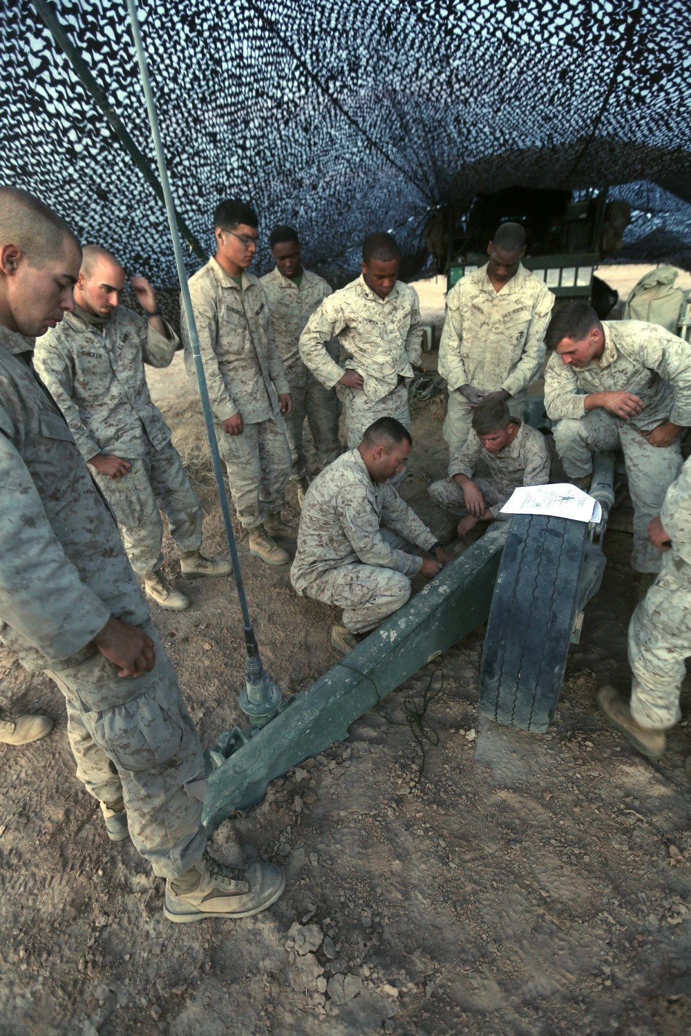 Gunnery Sgt. David Marinelarna, the field artillery chief of 2nd Battalion 11th Marine Regiment, demonstrates the proper way to secure  gear on the M777A2 light weight howitzer before a helicopter lift during Exercise Desert Scimitar at Marine Corps Air Ground Combat Center Twentynine Palms, Calif., May 8 2014. Desert Scimitar is a two-week, combined-element exercise to prepare Marines for deployments.  A helicopter is able to transport the howitzer quickly to locations that would otherwise be inaccessible. (U.S. Marine Corps photo by Lance Cpl. Ashton Buckingham)