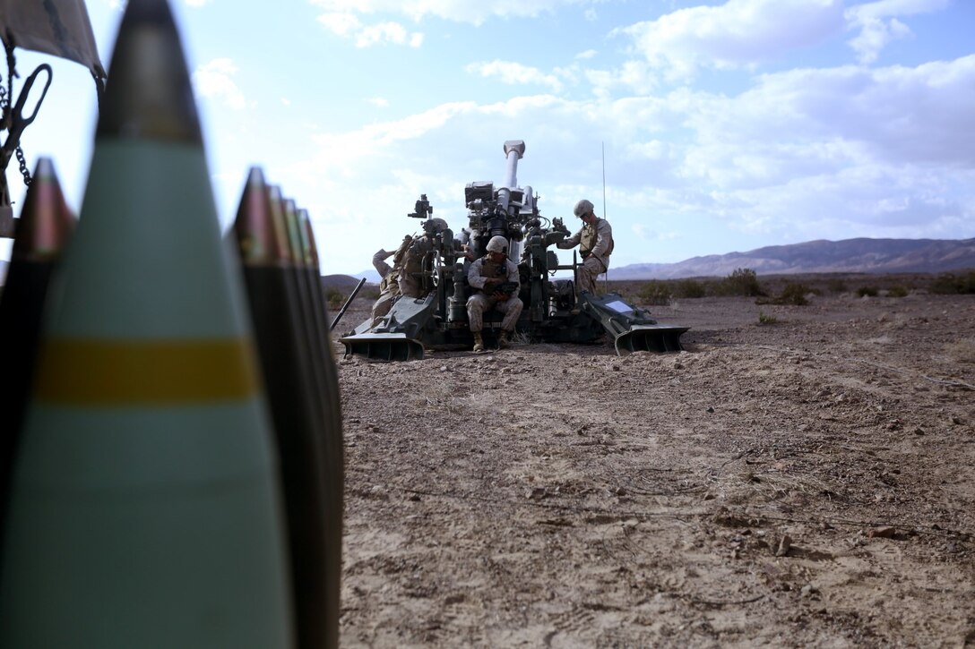 Marines with Fox Battery, 2nd Battalion, 11th Marine Regiment, wait for orders from the fire direction control during Exercise Desert Scimitar at Marine Corps Air Ground Combat Center Twentynine Palms, Calif., May 7, 2014.  Desert Scimitar is a two-week, combined-element exercise to prepare Marines for future deployments. (U.S. Marine Corps photo by Lance Cpl. Ashton Buckingham)
