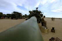Private Korey Kelemen, 22, an artilleryman with  Fox Battery, 2nd Battalion,  11th Marine Regiment,  sits on a howitzer tire during Exercise Desert Scimitar at Marine Corps Air Ground Combat Center Twentynine Palms, Calif., May 5, 2014.  Kelemen, a native of Detroit, Mich., is the ammo man for gun one in Fox battery during the exercise. Desert Scimitar is a two-week, combined-element exercise to prepare Marines for future deployments. (U.S. Marine Corps photo by Lance Cpl. Ashton Buckingham)
