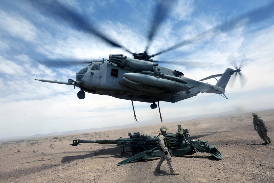 A Ch-53 super stallion helicopter sets a M777A2 lightweight howitzer down during Exercise Desert Scimitar at Marine Corps Air Ground Combat Center Twentynine Palms, Calif., May 8 2014. Desert Scimitar is a two-week, combined-element exercise to prepare Marines for deployments.  The Ch-53 is able to transport a howitzer quickly to locations that would otherwise be inaccessible. (U.S. Marine Corps photo by Lance Cpl. Ashton Buckingham)