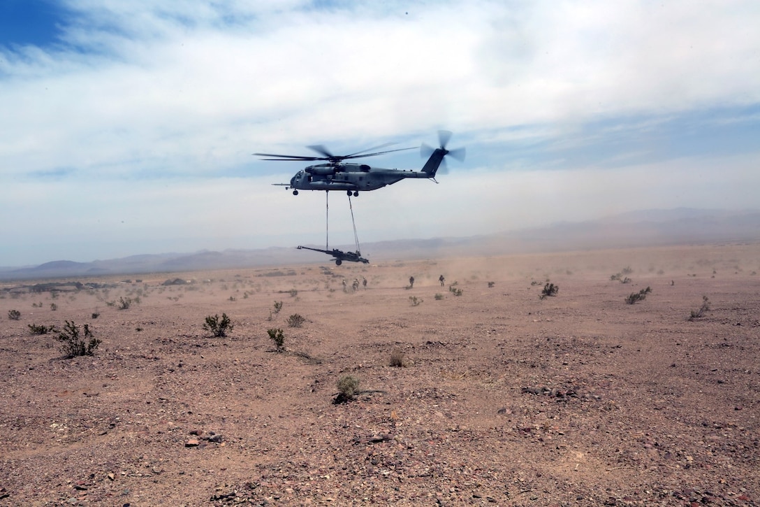 A Ch-53 super stallion helicopter lifts a M777A2 lightweight howitzer during Exercise Desert Scimitar at Marine Corps Air Ground Combat Center Twentynine Palms, Calif., May 8 2014. Desert Scimitar is a two-week, combined-element exercise to prepare Marines for deployments.  The Ch-53 is able to transport a howitzer quickly to locations that would otherwise be inaccessible. (U.S. Marine Corps photo by Lance Cpl. Ashton Buckingham)